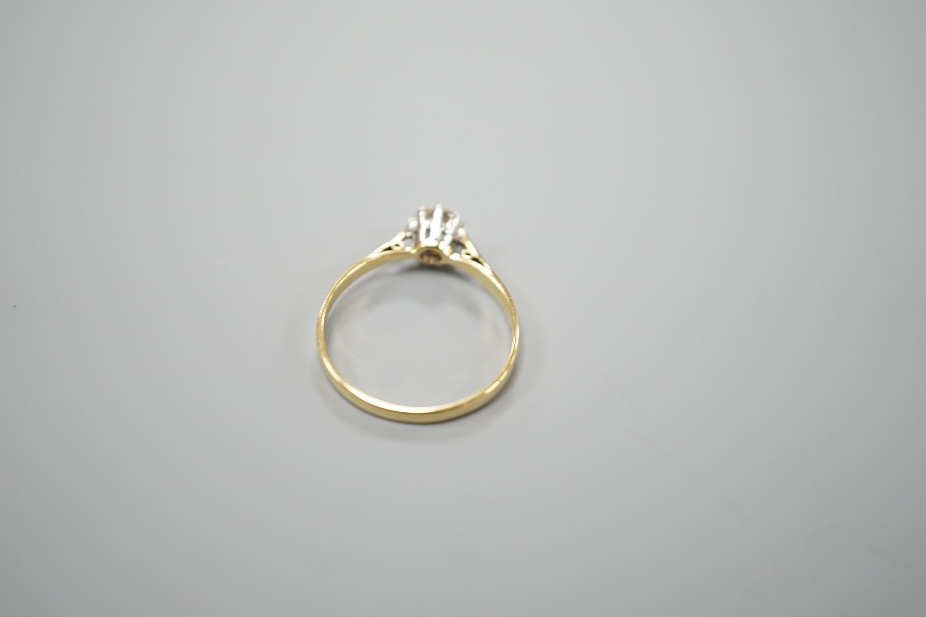 A yellow metal and simulated solitaire diamond ring, size O, gross weight 1.6 grams.